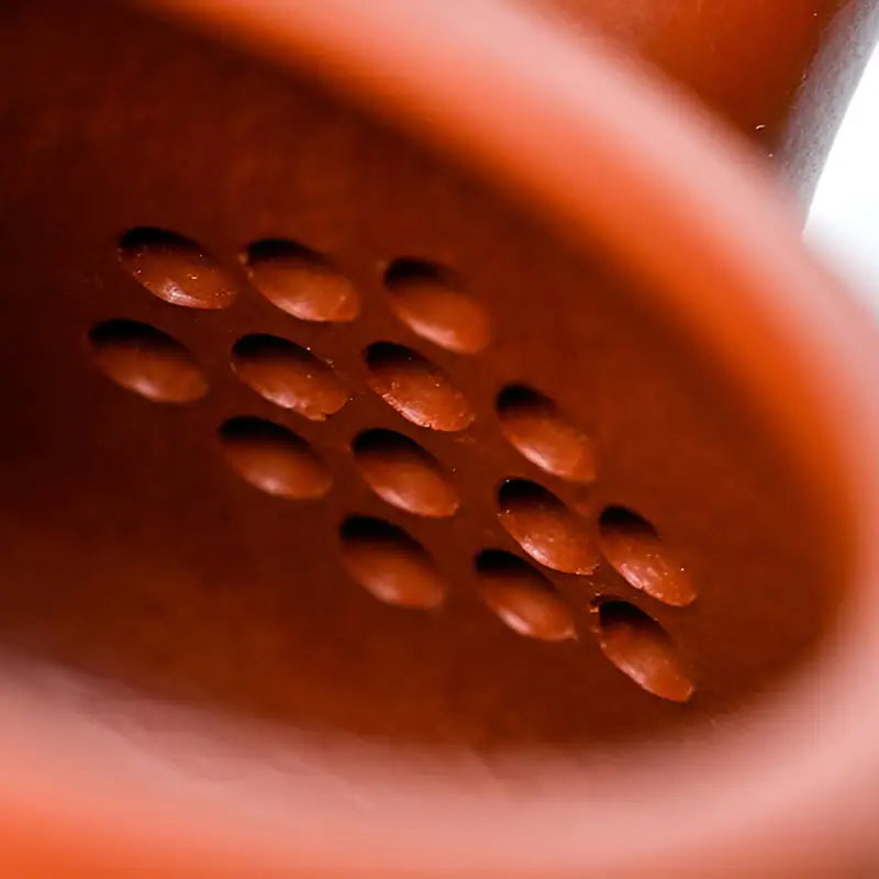 Orange telephone receiver with speaker holes from Scholar’s Flame, ideal for gongfu tea sessions