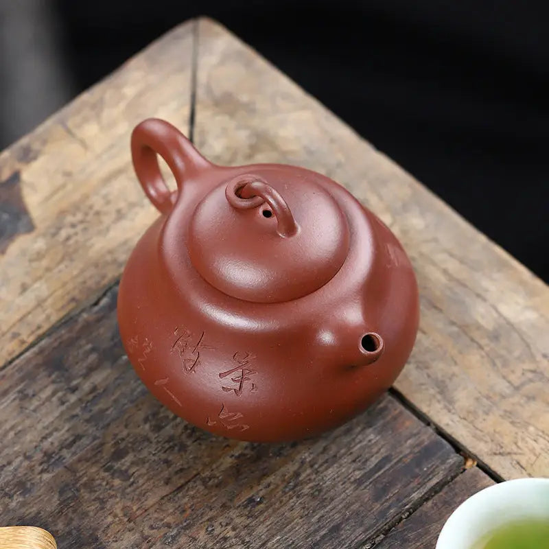 Round reddish-brown handcrafted Yixing Zisha teapot with side spout for Scholar’s Rest
