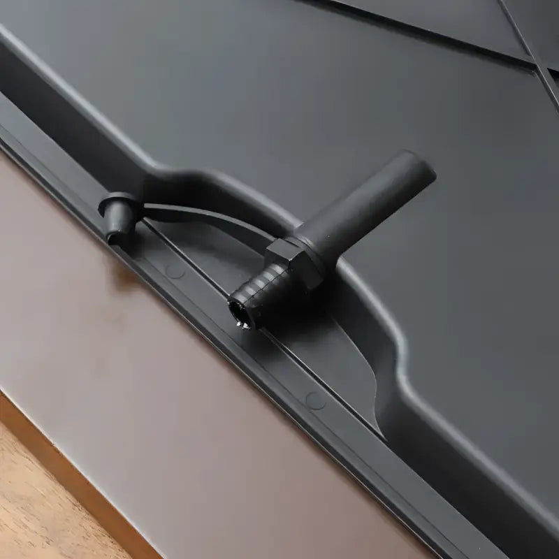 Black plastic drain fitting for Serene Flow bamboo tea tray with eco-friendly design