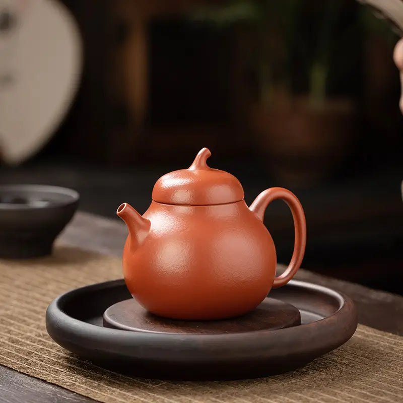 Terracotta teapot with rounded body from Serenity Glow Tea Set made of Yixing Zisha clay