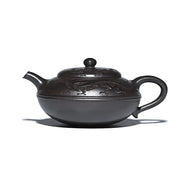 Dark brown Yixing teapot with shadow dragon carvings made from Zisha clay