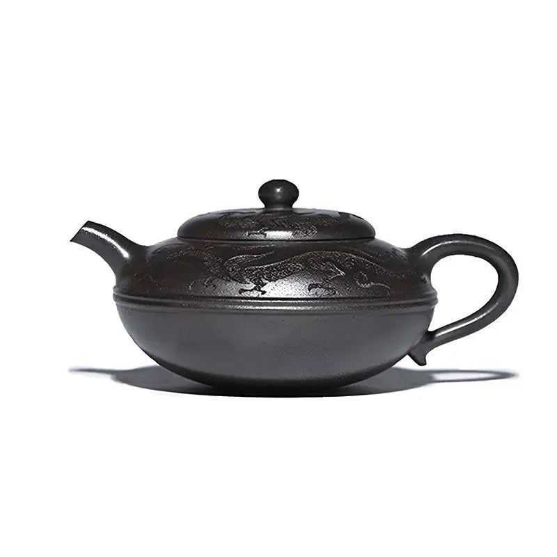 Dark brown Yixing teapot with shadow dragon carvings made from Zisha clay