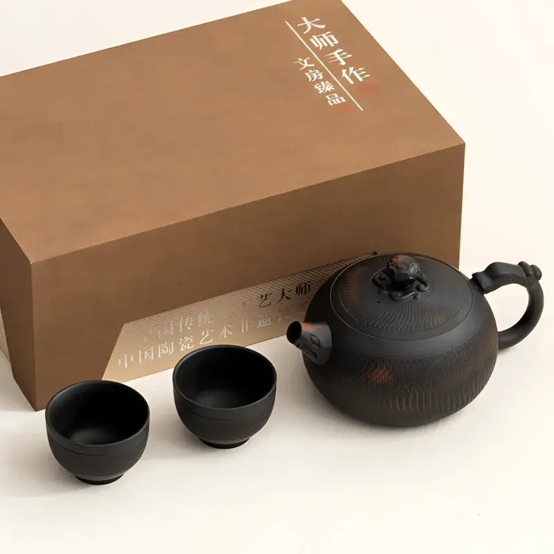 Shadow Lion Yixing Zisha tea set with box showcasing a dark ceramic teapot set