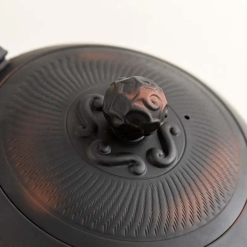 Ornate black Yixing Zisha teapot lid from the Shadow Lion Tea Set