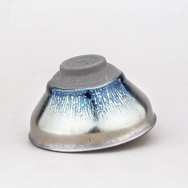 Shiny Jian Zhan ceramic bowl with reflective blue and silver glaze for tea brewing