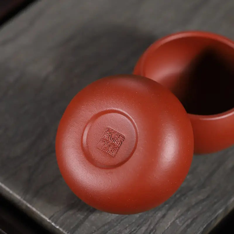 Reddish-brown ceramic tea cup from Silent Curve Cup made of Yixing Zisha Clay for Gongfu Tea