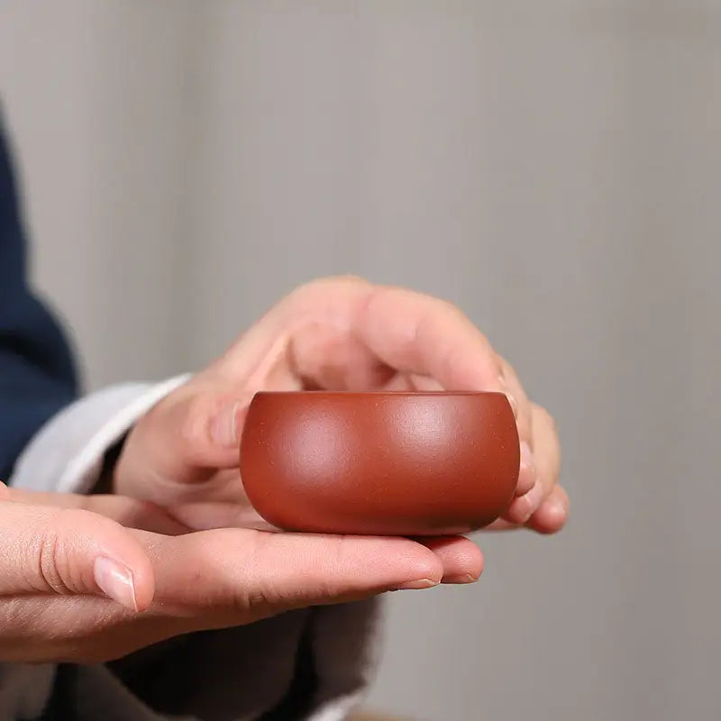Small reddish-brown ceramic bowl from Silent Curve Cup, made of Yixing Zisha clay for gongfu tea