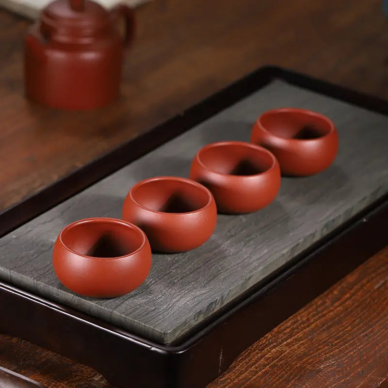 Reddish-brown ceramic Silent Curve Cup made from Yixing Zisha clay for Gongfu tea brewing