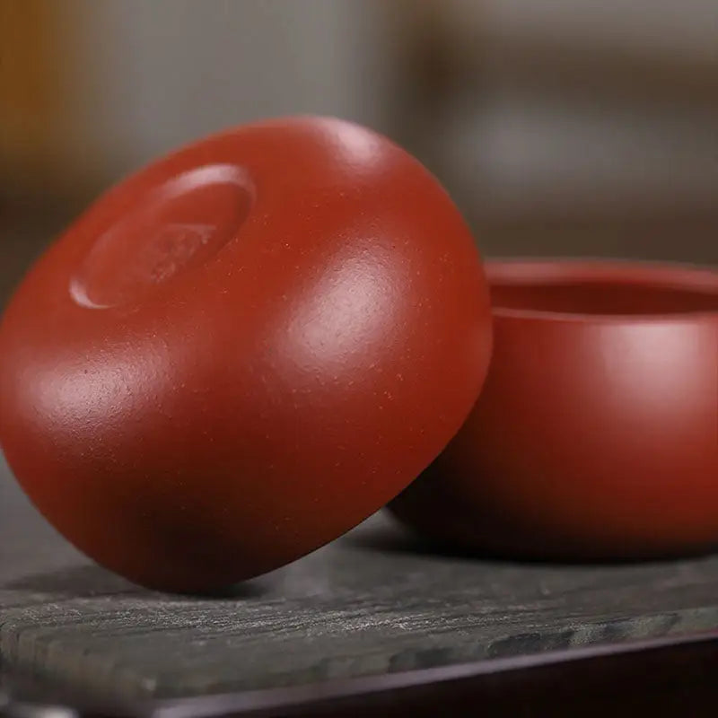 Reddish-brown ceramic Silent Curve Cup made from Yixing Zisha clay for gongfu tea brewing