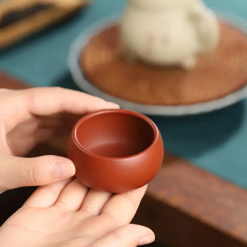 Small round reddish-brown Silent Curve Cup made from Yixing Zisha clay for Gongfu tea