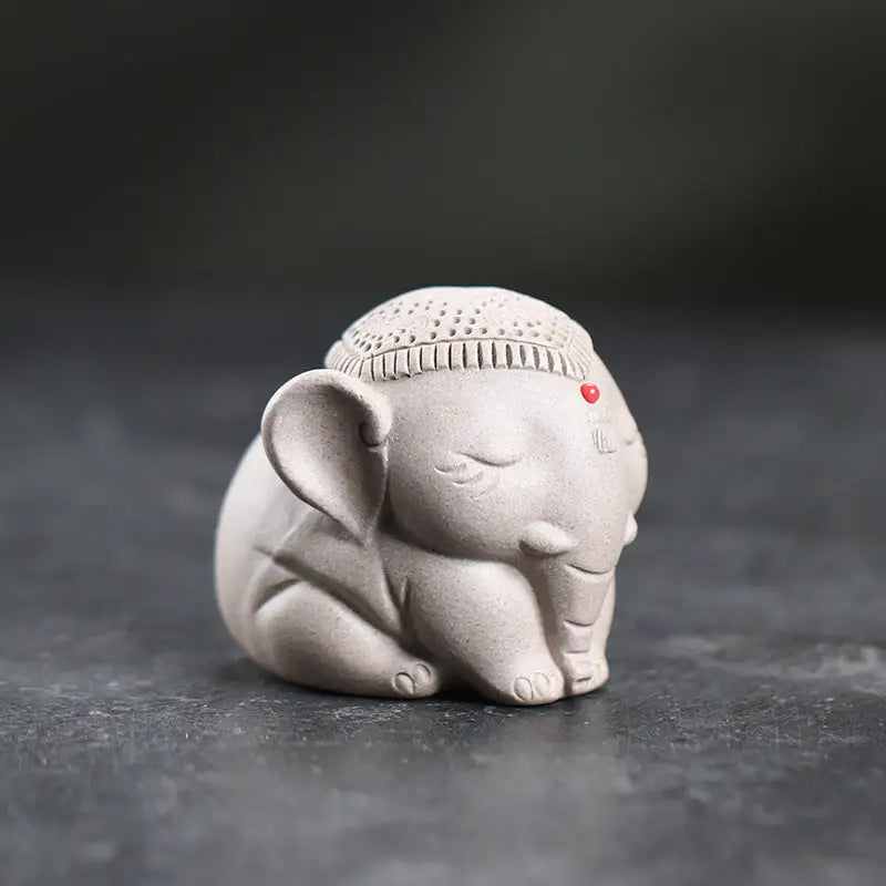 Sleeping elephant figurine with hat from Silent Dharma, an elephant tea pet in Yixing Zisha clay