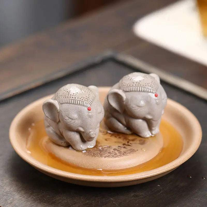 Silent Dharma elephant tea pet figurines on a saucer, Yixing Zisha style ceramic art