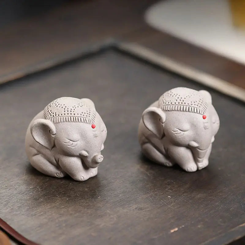 Silent Dharma elephant tea pet featuring two gray Yixing Zisha elephant figurines