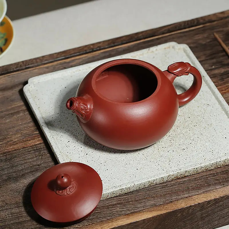 Reddish-brown Yixing Zisha Teapot Silent Sentinel with ornate handle and spout