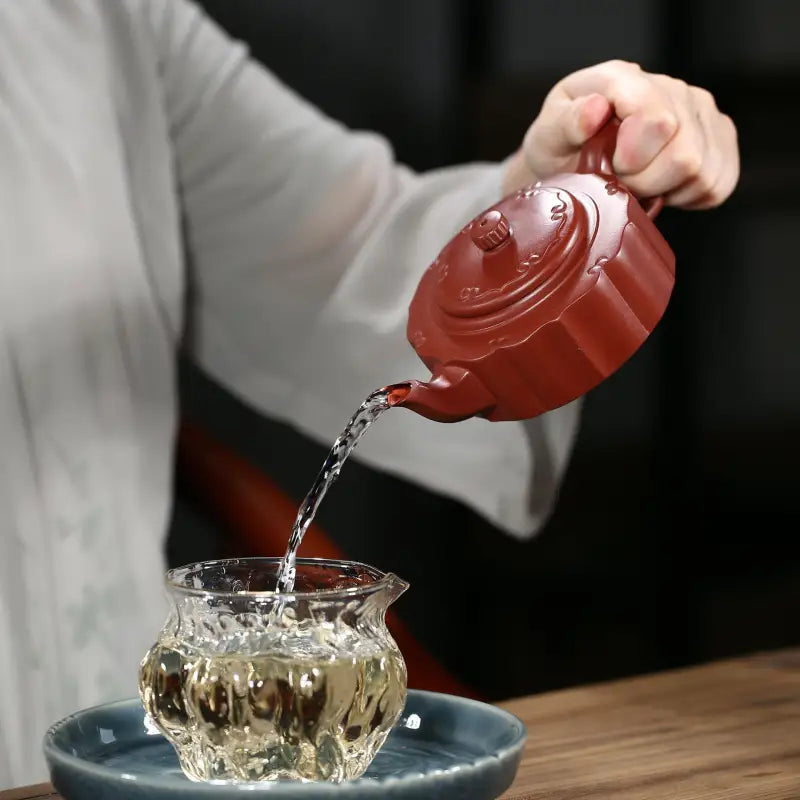Reddish-brown Yixing Zisha Clay Teapot pouring liquid from Silken Ridge product