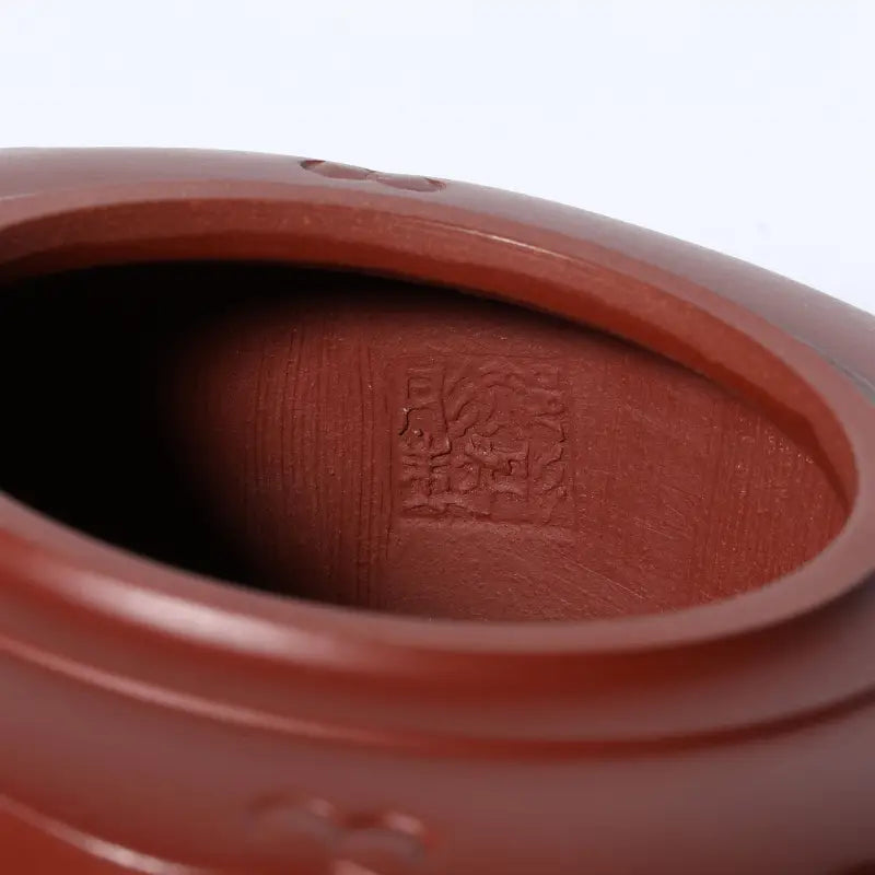 Reddish-brown Yixing Zisha clay tea pot interior with maker’s mark from Silken Ridge