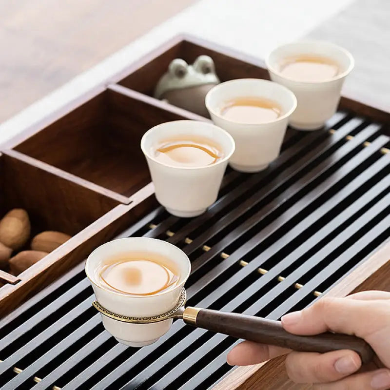 Tea cups on a wooden tray from the Six Gentlemen Tea Set for Gongfu Tea Ceremony