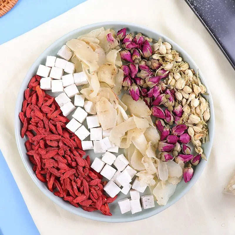 Assorted dried ingredients on a plate for herbal tea to enhance sleep quality and reduce hair loss