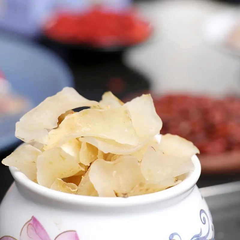 Translucent sliced food in decorative bowl for herbal tea to improve sleep quality and reduce hair loss