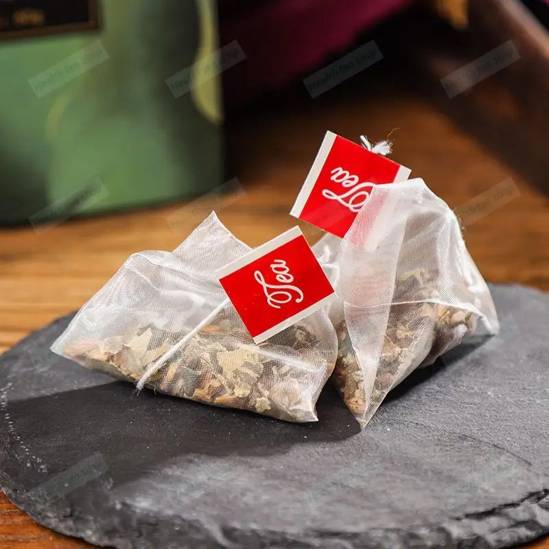 Two pyramid herbal tea bags for slimming tea and health-enhancing herbal tea benefits