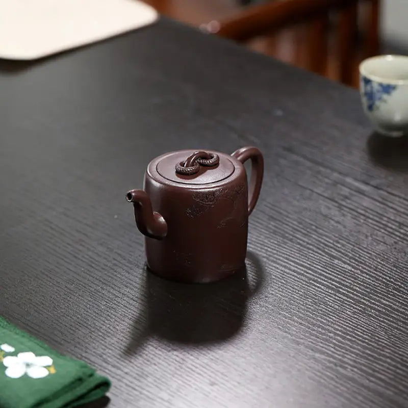 Brown ceramic Yixing Zisha teapot with carved crane and pine motif from Soaring Tranquility