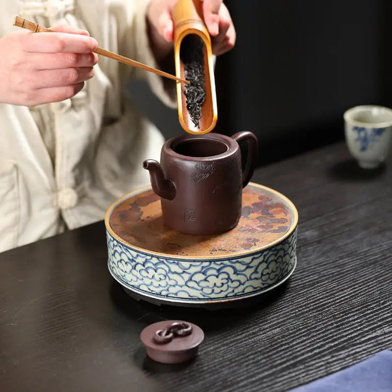 Brown clay Yixing Zisha teapot with carved crane and pine motif from Soaring Tranquility