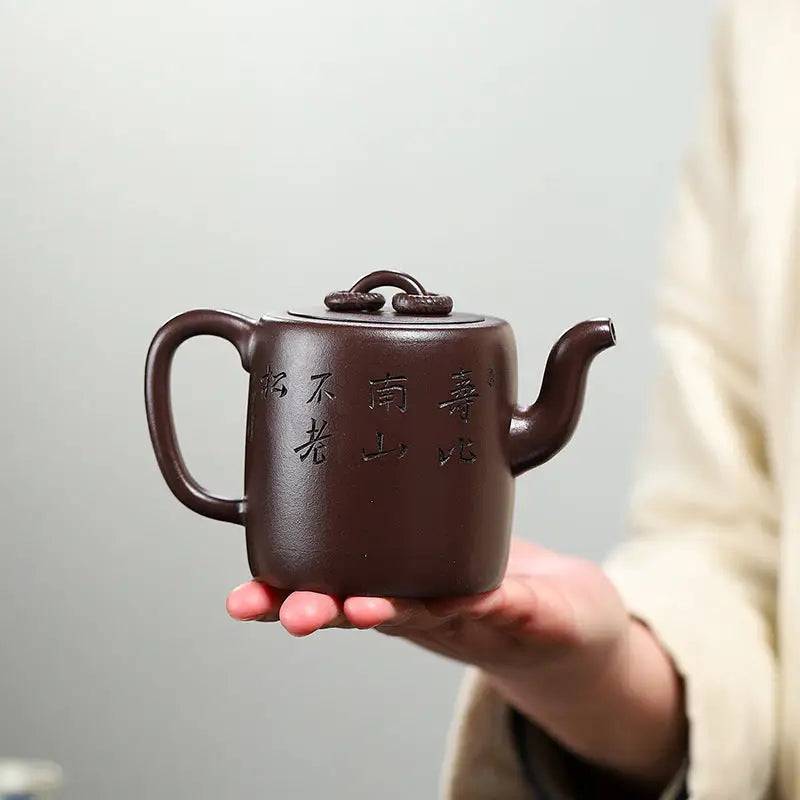 Brown ceramic Yixing Zisha Teapot with carved crane and pine motif in Soaring Tranquility