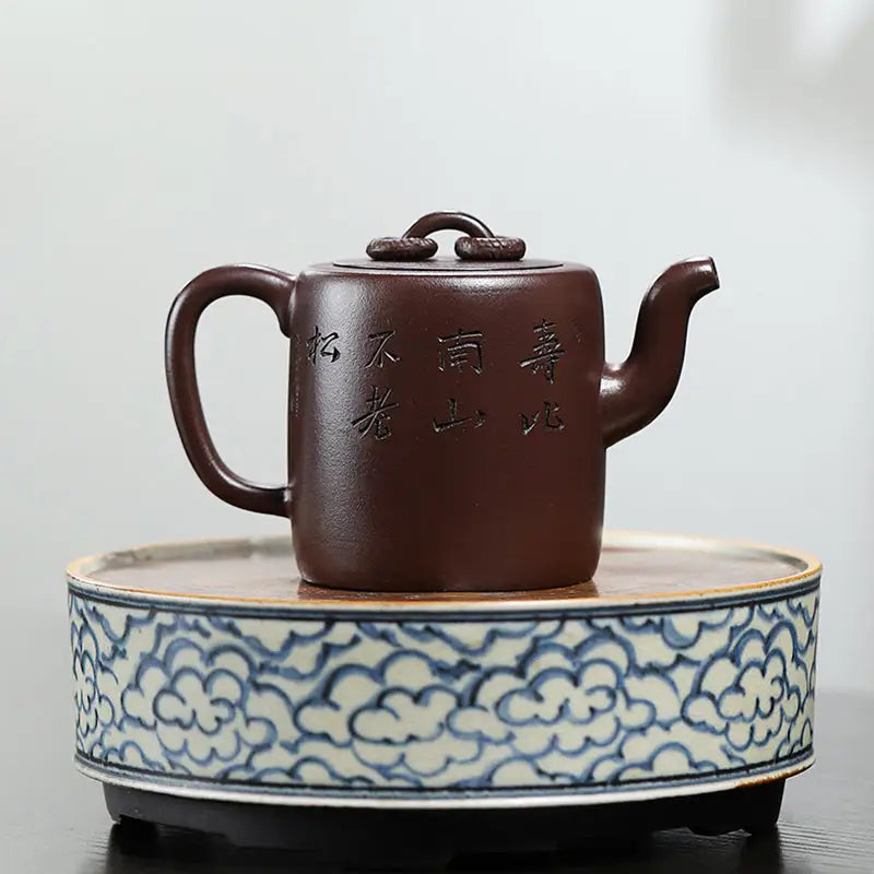 Brown ceramic Yixing Zisha Teapot with carved crane and pine motif in Soaring Tranquility