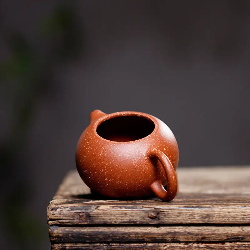 Round brown ceramic Stardust Harmony teapot made from Yixing Zisha clay for authentic Gongfu tea