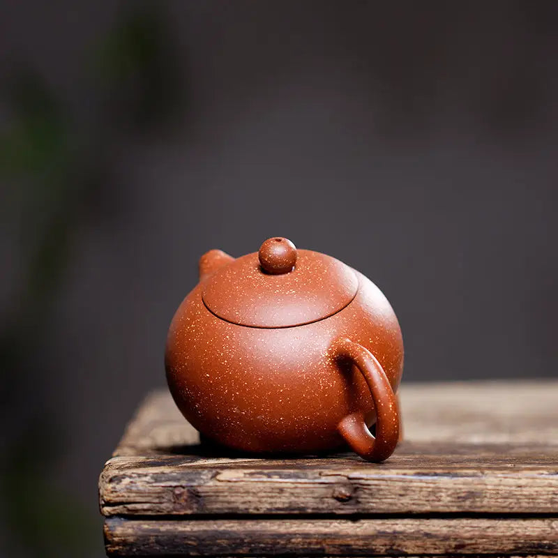 Round reddish-brown Stardust Harmony Teapot made from Yixing Zisha clay for authentic Gongfu tea