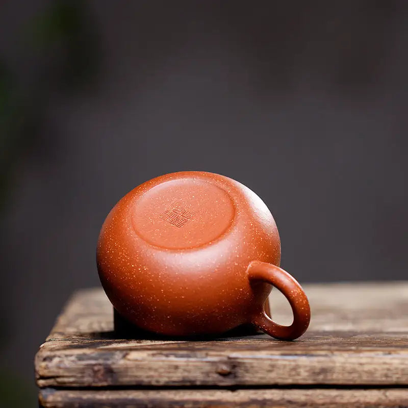 Reddish-brown ceramic cup with handle from Stardust Harmony teapot made of Yixing Zisha clay for authentic Gongfu tea