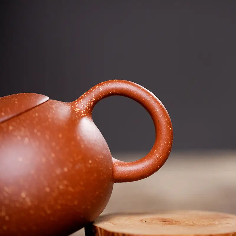 Earthenware Stardust Harmony teapot with circular handle made from Yixing Zisha clay for authentic Gongfu tea