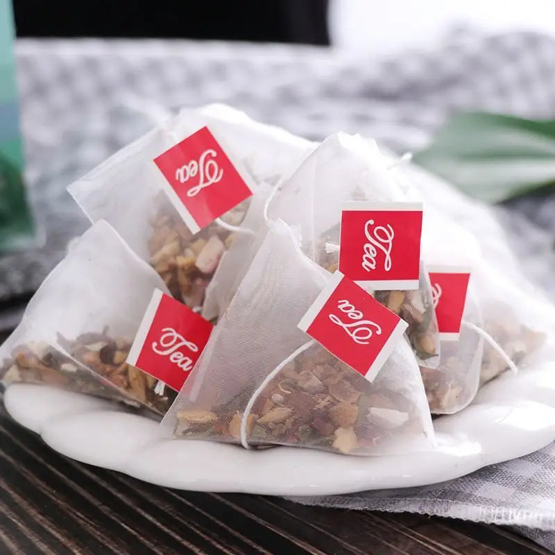 Pyramid-shaped herbal tea health bags with red tags for health-enhancing herbal tea wellness