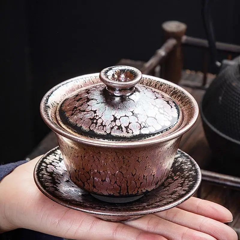 Metallic tea cup with lid and saucer from Succulent Tea Set featuring Tenmoku Pottery design