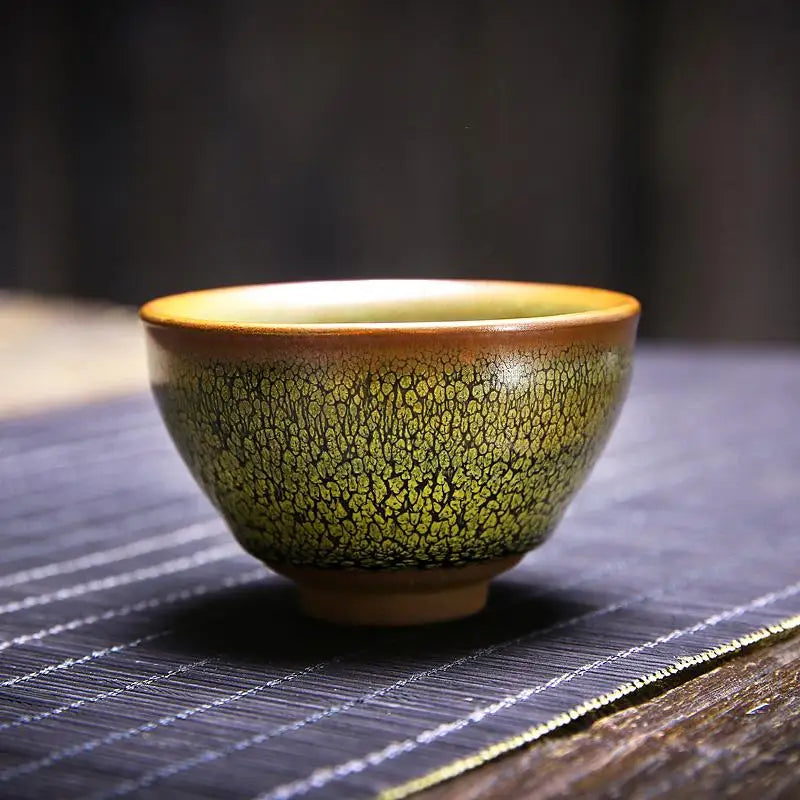 Green and brown ceramic teacup from Sunflower Tea Set featuring Jianyang glaze for Gongfu tea