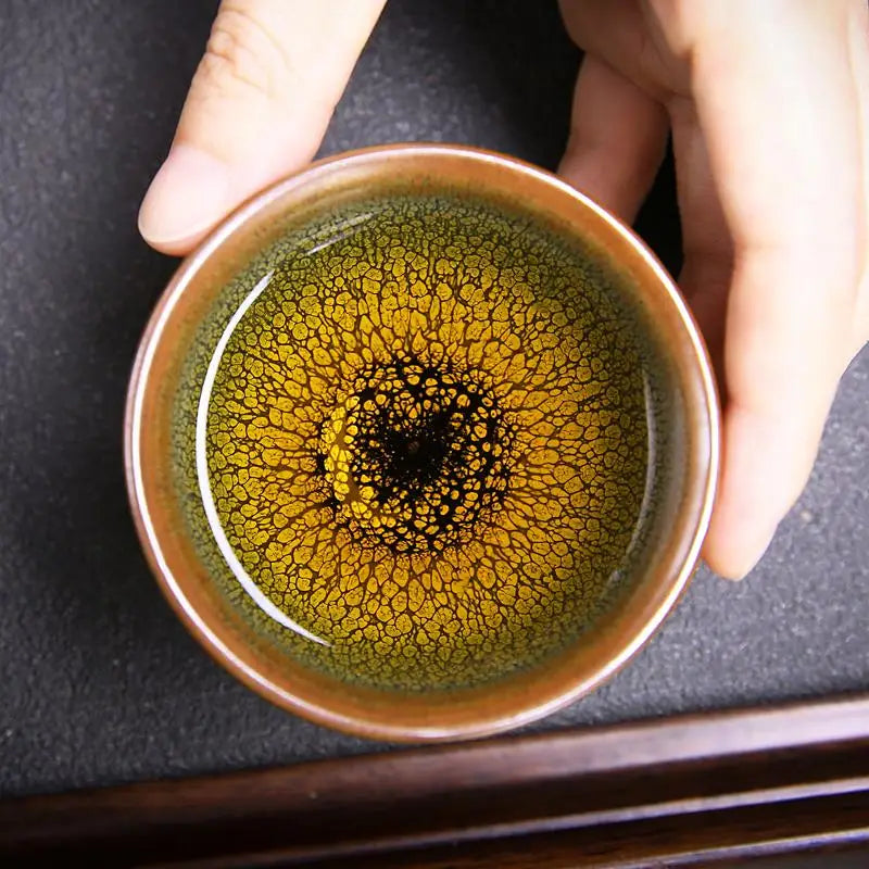 Ceramic tea cup with golden-brown Jianyang glaze from Sunflower Tea Set for gongfu tea