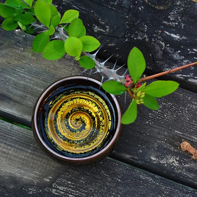 Swirl Jian Zhan round bowl with golden spiral crackle glaze for Gongfu tea brewing