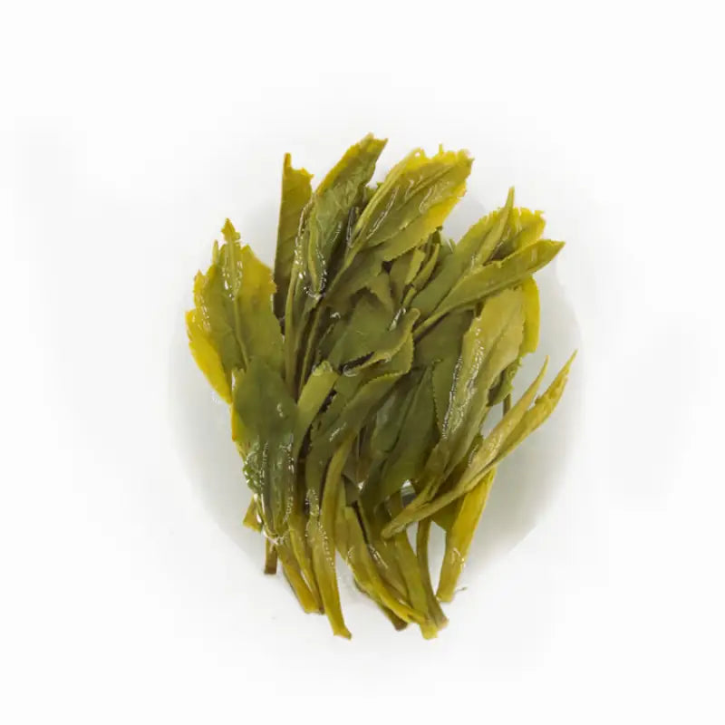 Pile of green tea leaves from Taiping Houkui Orchid Aroma Green Tea spring harvest