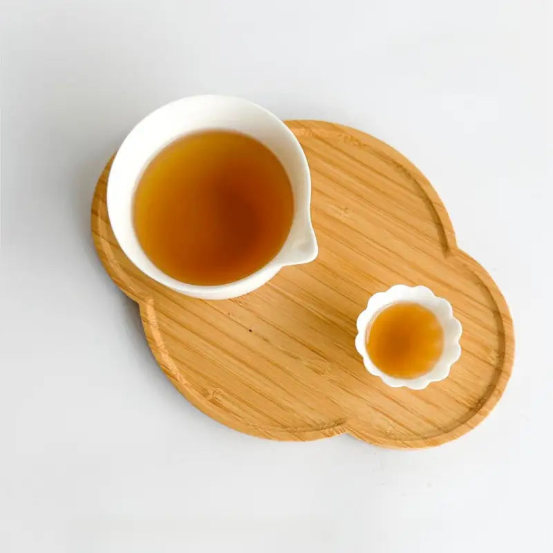 Tanyang Black Tea with delicate floral aroma in two white ceramic cups on wooden tray