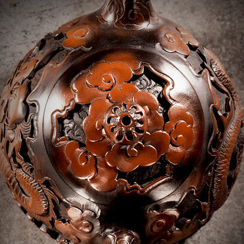 Ornate dark brown carved vase from The Dragon featuring jianshui purple Zitao teapot design