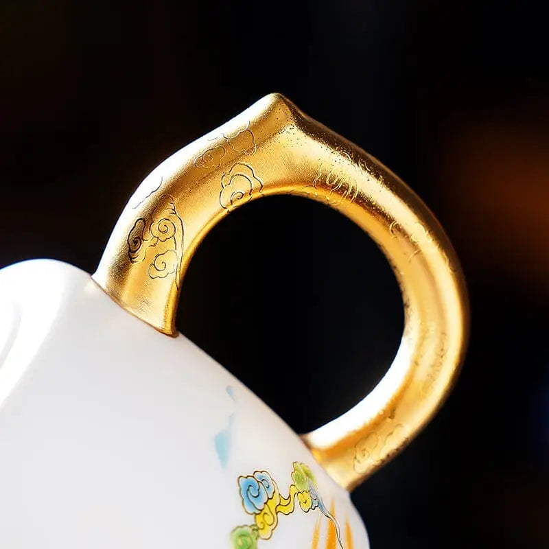 Elegant white teacup with gold handle featuring Jingdezhen enamel art and golden accents for The Dragon product
