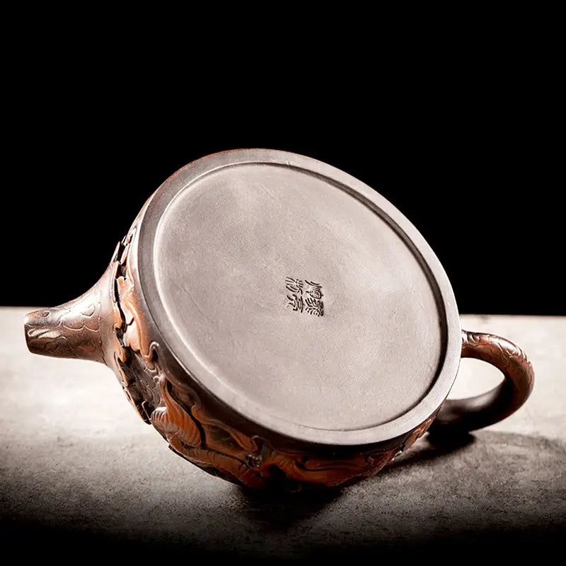 Ornate brown Jianshui Zitao teapot with silver base from The Dragon collection