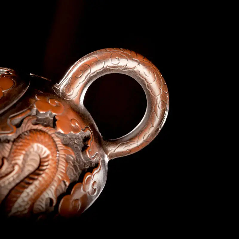 Ornate copper Zitao teapot with dragon motif, showcasing Jianshui Zitao craftsmanship