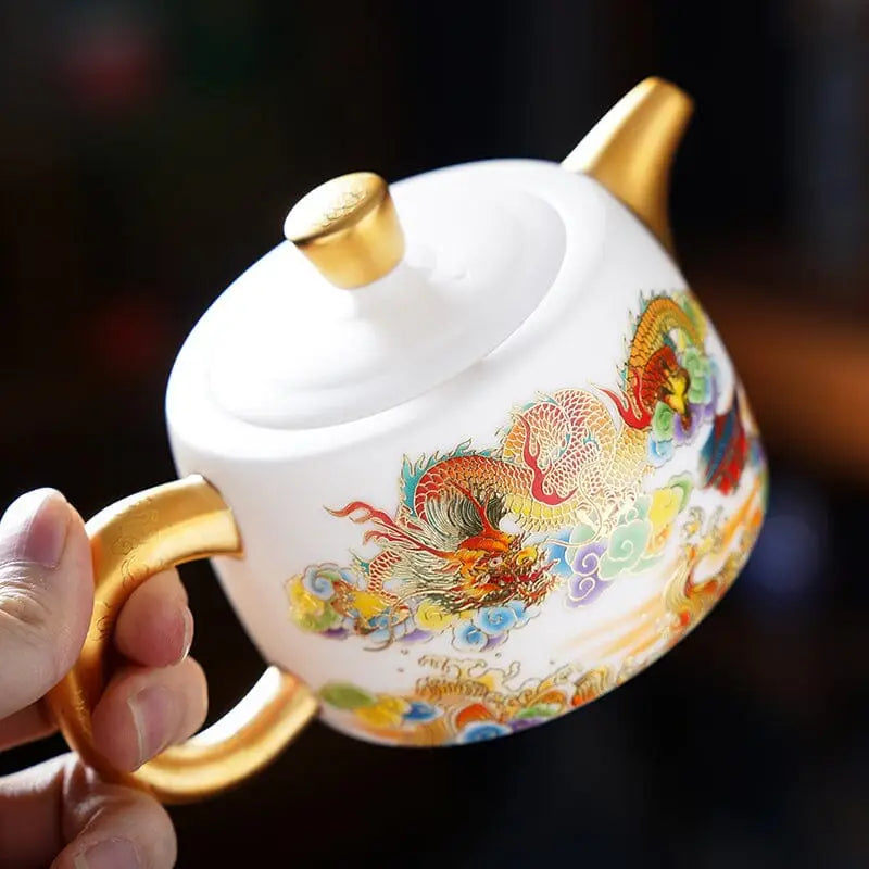 White hand-painted Jingdezhen teapot with dragon design and golden accents in Jingdezhen enamel art