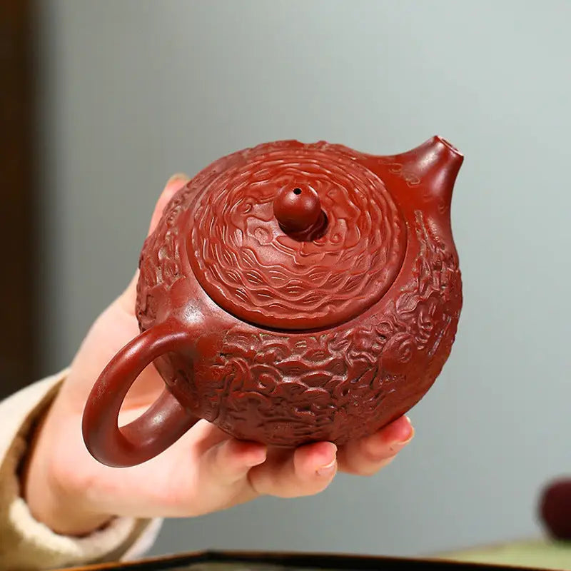 Ornate reddish-brown Yixing Zisha clay teapot with dragon relief from The Dragon series