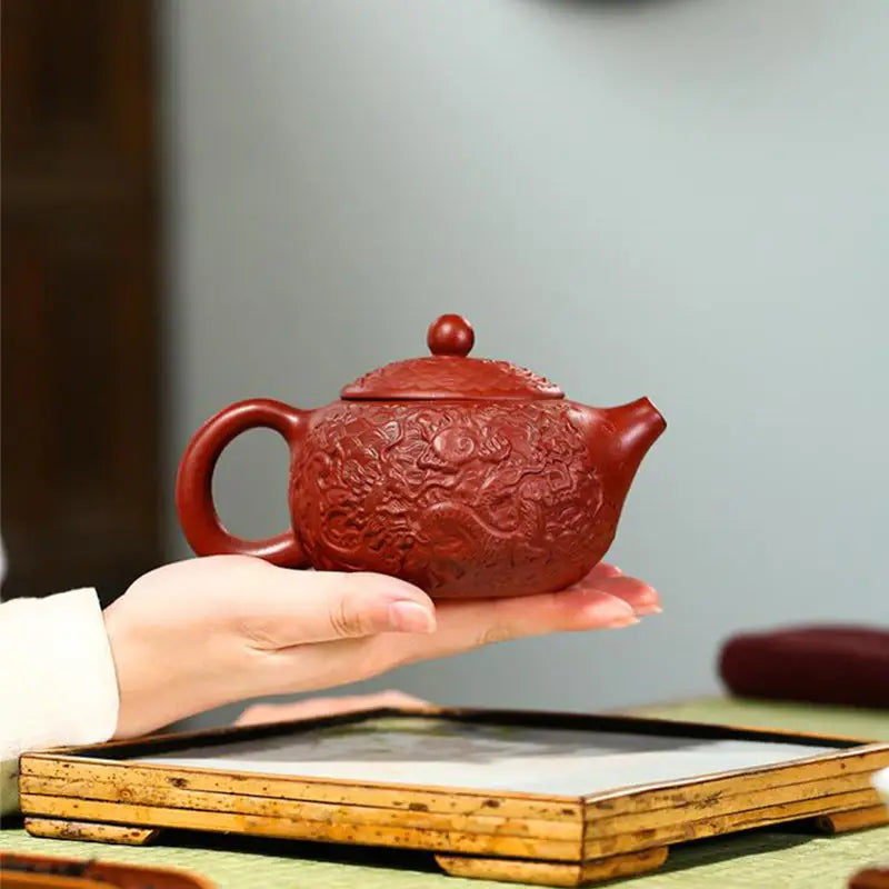 Ornate reddish-brown Yixing Zisha clay teapot with dragon relief design in The Dragon product