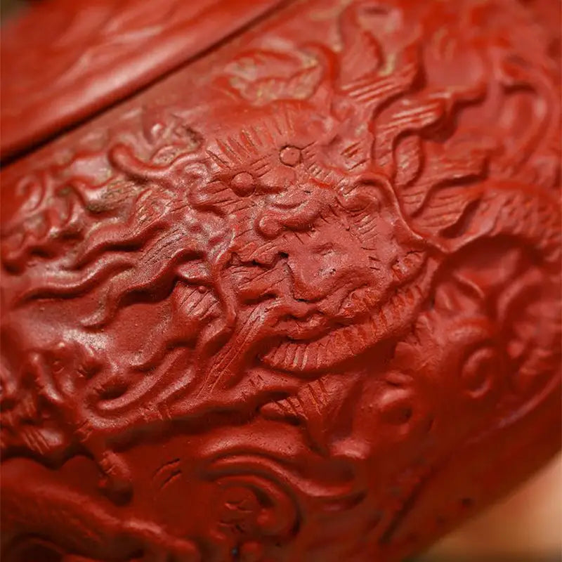 Red carved dragon design on The Dragon product in Yixing Zisha clay with dragon relief details