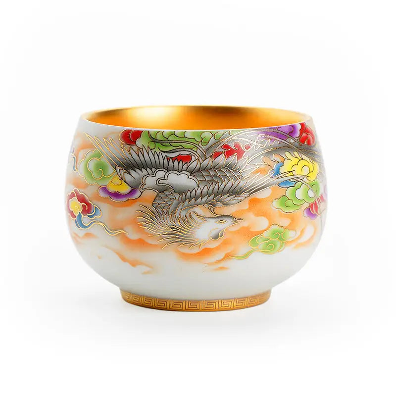 Ornate porcelain tea cup with golden interior from The Phoenix for gongfu tea brewing
