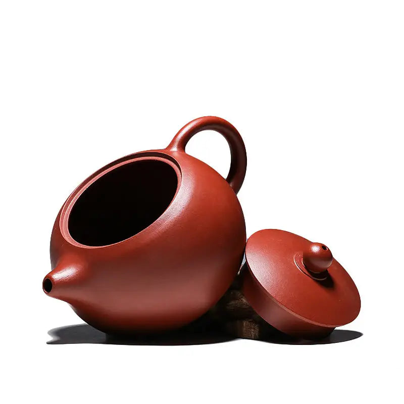 Reddish-brown handmade Yixing Zisha red clay teapot with separate lid from The Still Moon