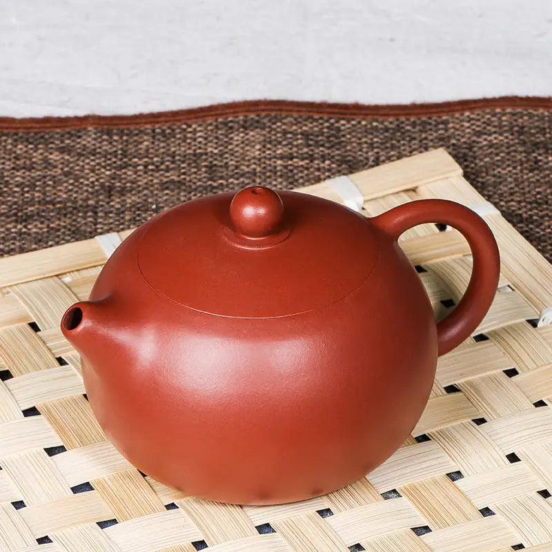 Round reddish-brown teapot made of handmade Yixing Zisha red clay for tea lovers